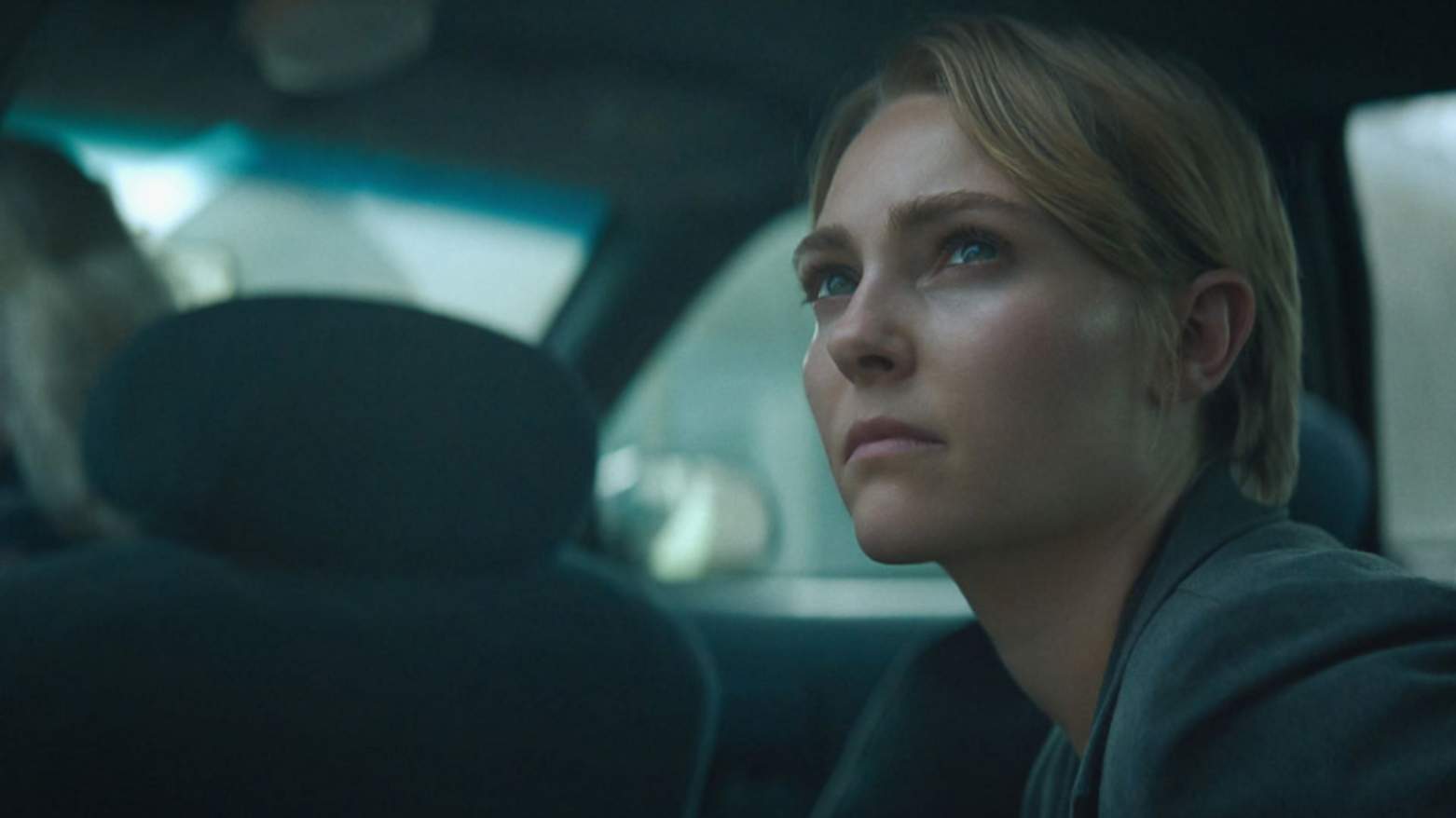 AnnaSophia Robb in the movie Rebel Ridge, waiting patiently in a car, staring out in anticipation
