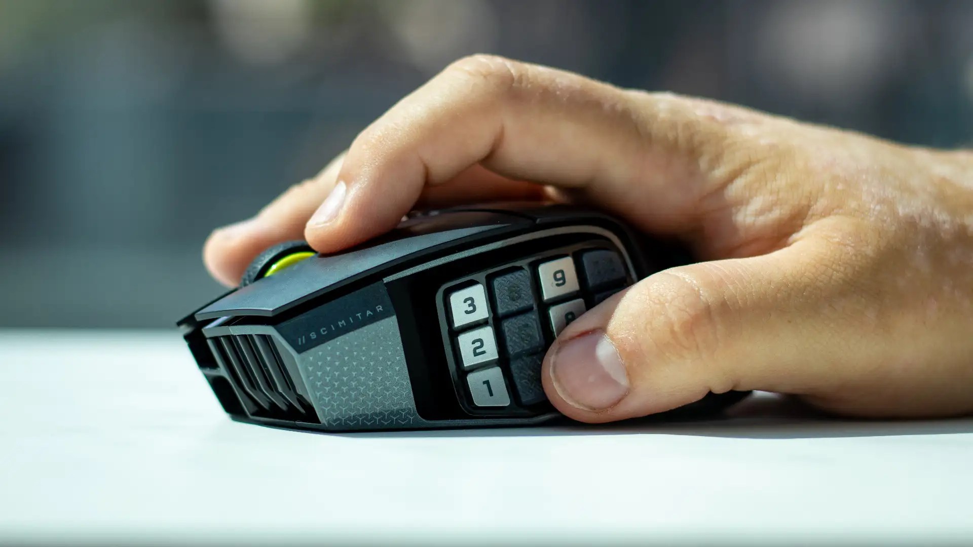 The Corsair Scimitar Elite Wireless SE mouse being held in-hand