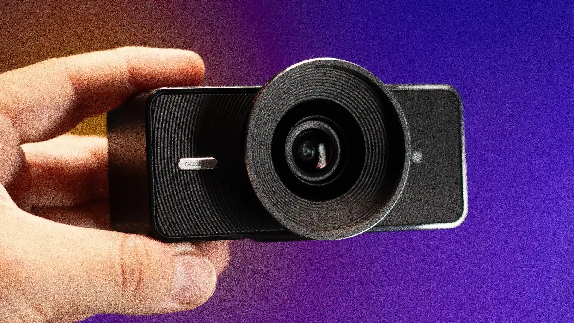 The Elgato Facecam 4K being held in hand against a gradient background