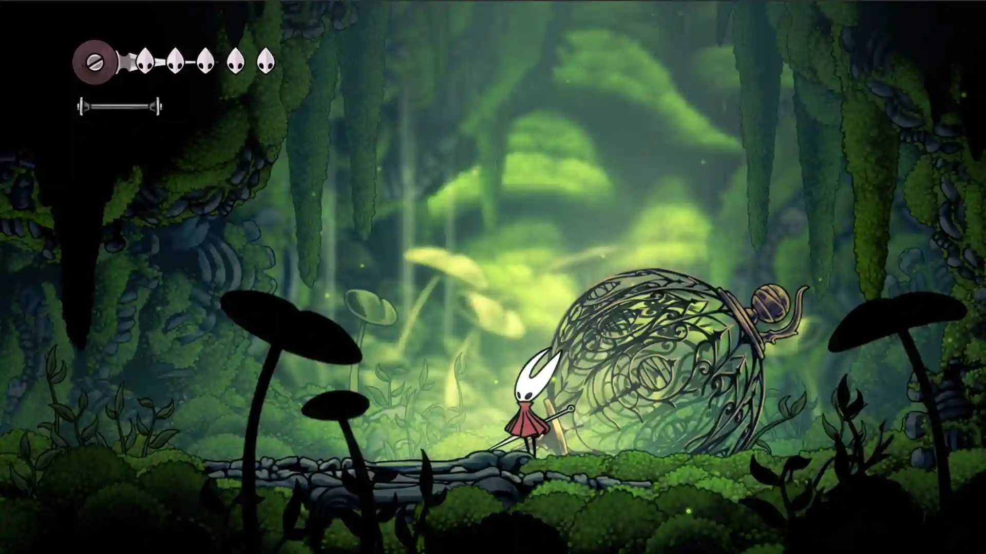 Hornet walks through a lush, green cavern filled with moss and giant mushrooms. To her right is a large, ornate bell with a snail on top. Screenshot from Hollow Knight: Silksong.