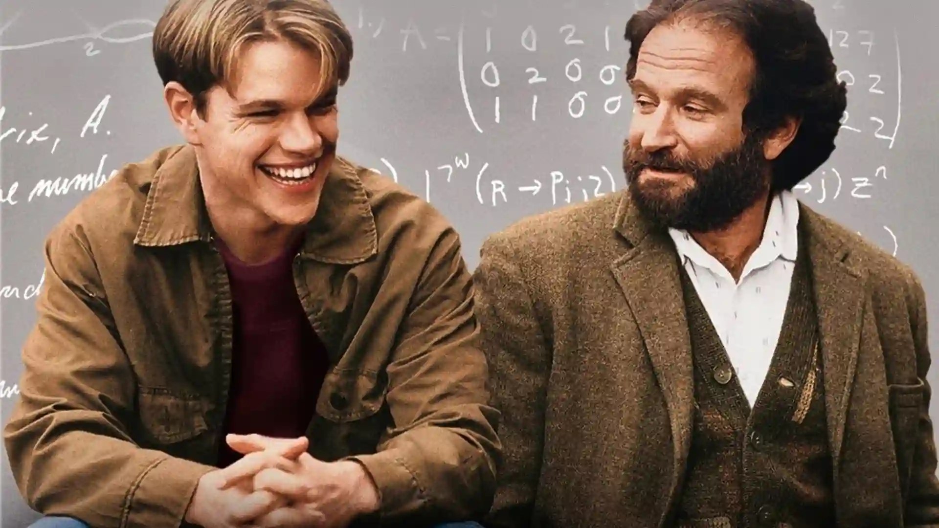 Will Hunting (Matt Damon) laughing with his therapist Sean Maguire (Robin Williams) in front of a chalkboard of equations.