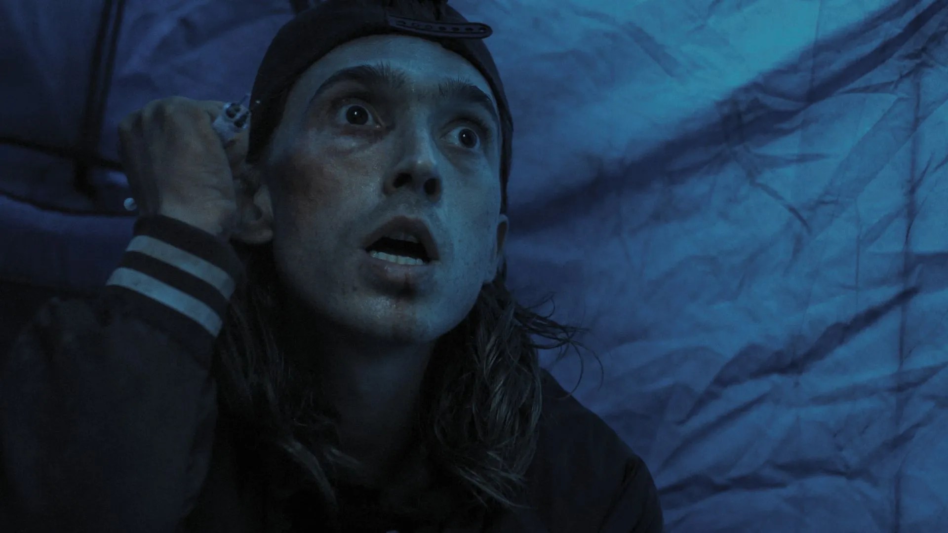 Weapons (2025) Movie Screenshot - James (Austin Abrams) holding needles, ready to attack.